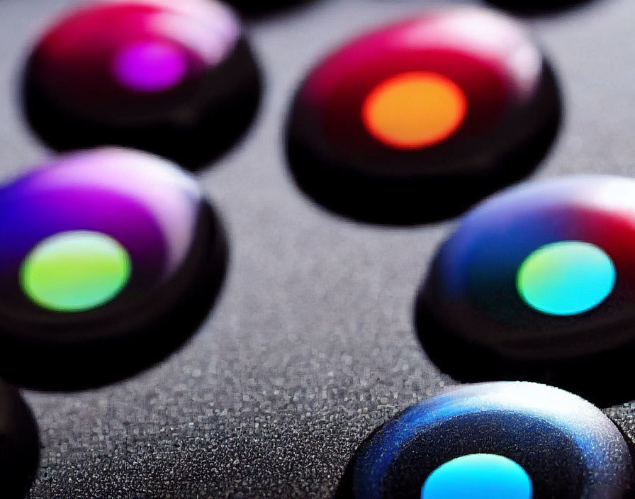 Vibrant illuminated arcade buttons in blue, green, orange, and pink