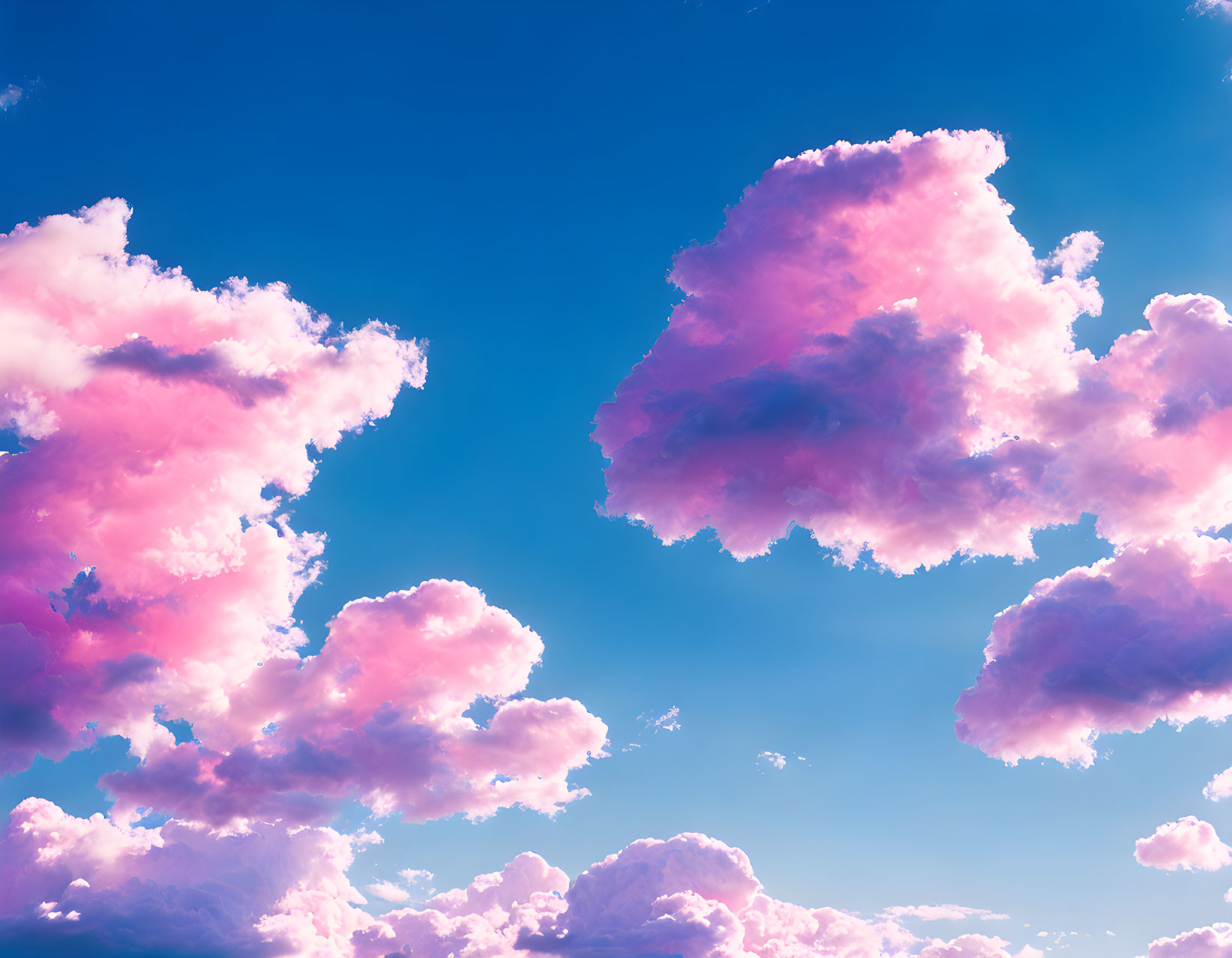 Pink clouds in vibrant blue sky: dreamy and surreal scene