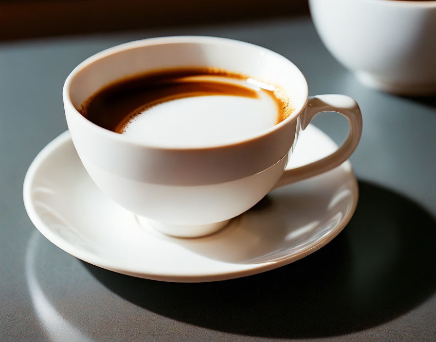 White Coffee Cup with Cream on Saucer in Warm Sunlight