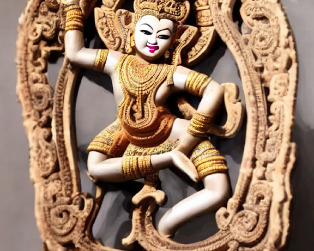 Intricate four-armed dancing figure in ornate headgear and costume within decorative frame