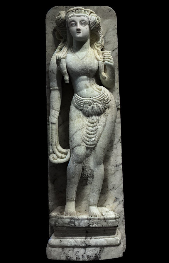 Ancient stone sculpture of female figure in contrapposto pose