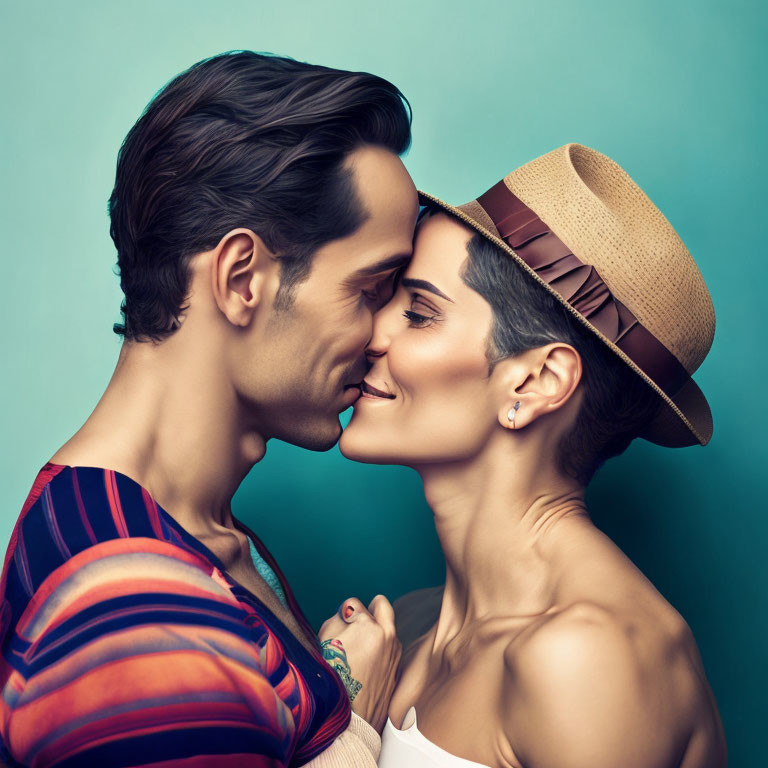 Man and woman about to kiss, touching noses against teal background. Man in striped shirt, woman in