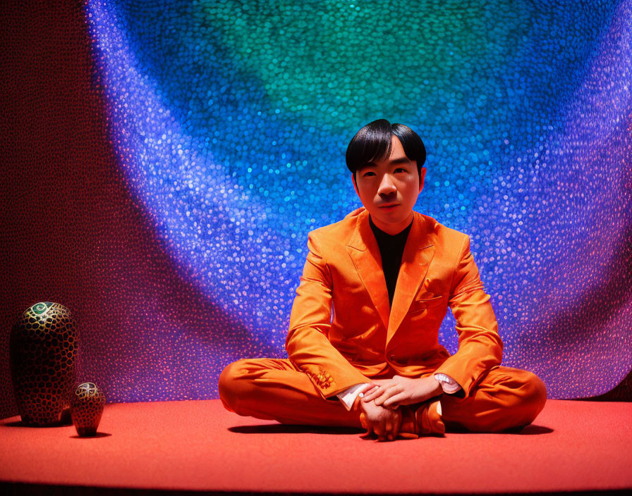 Person in Bright Orange Suit Against Blue Background with Vases