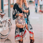 Woman in Patchwork Robe Surrounded by Geometric and Floral Designs