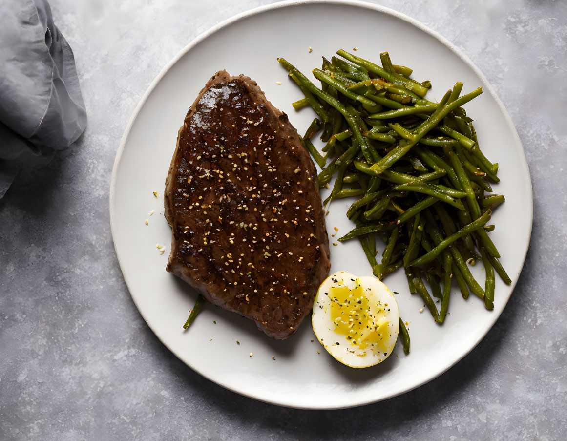 Sesame Seed Grilled Steak with Green Beans and Egg on White Plate