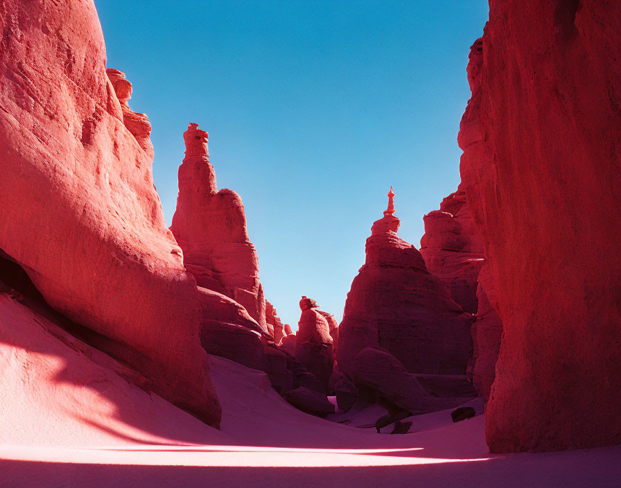 Desert landscape with red-hued rock formations and sand