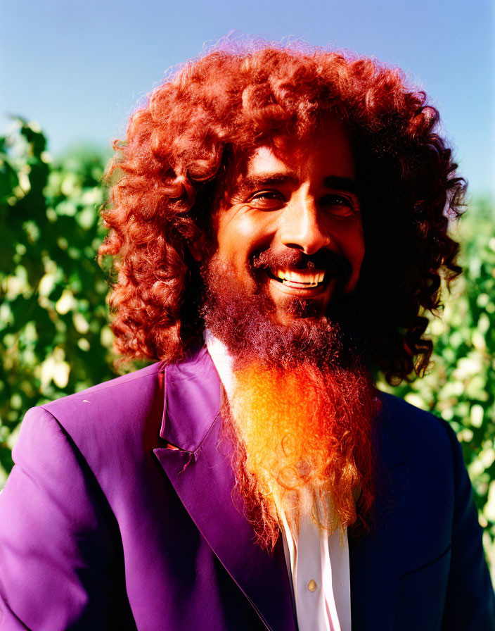 Curly Ombré Beard Man in Bright Purple Suit Outdoors