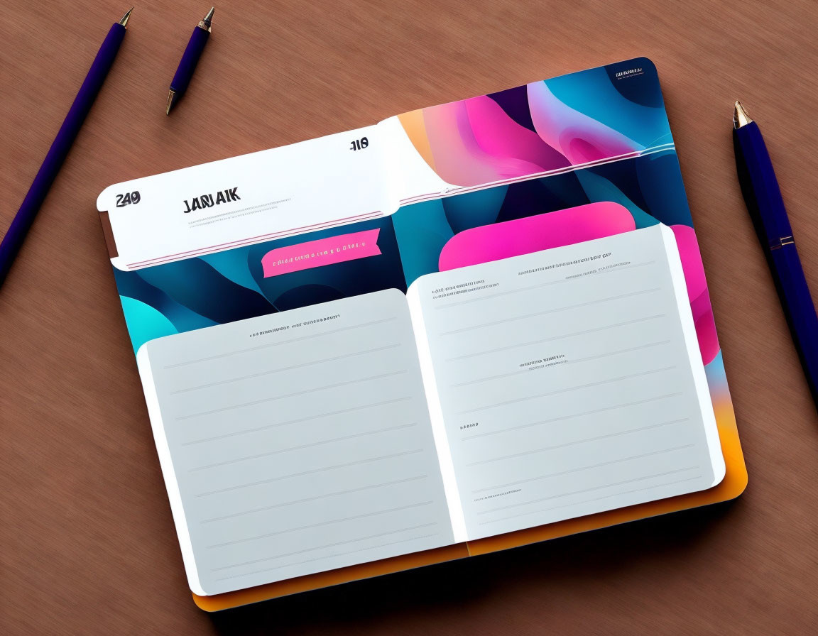 Colorful Abstract Design Open Planner on Wooden Desk with Blue Pens