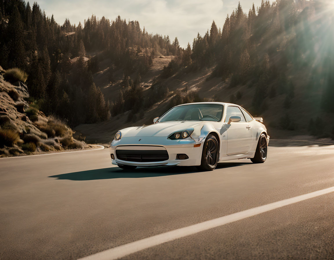 White sports car parked on mountain road with trees and sunlight.