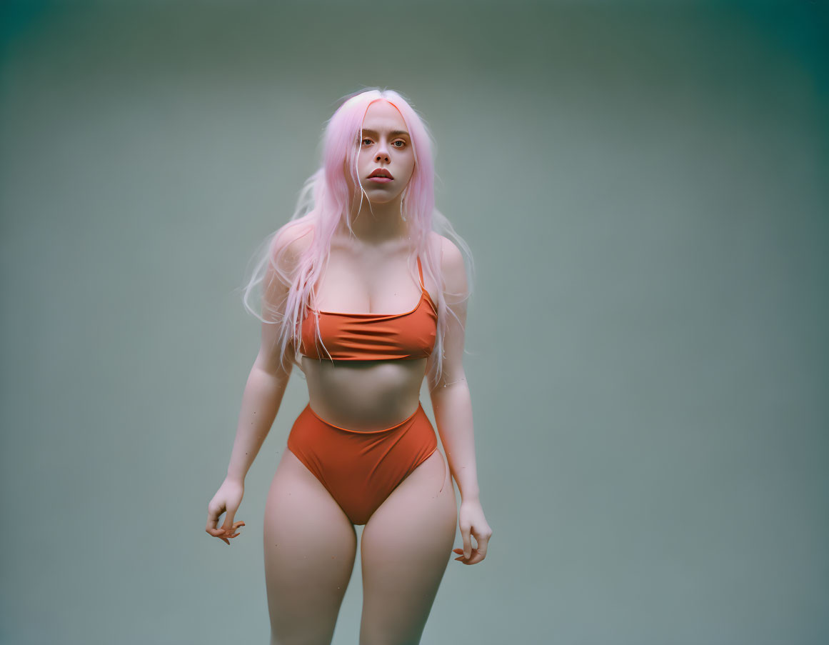 Orange Swimsuit Woman with Pastel Pink Hair on Greenish-Grey Background |  Deep Dream Generator