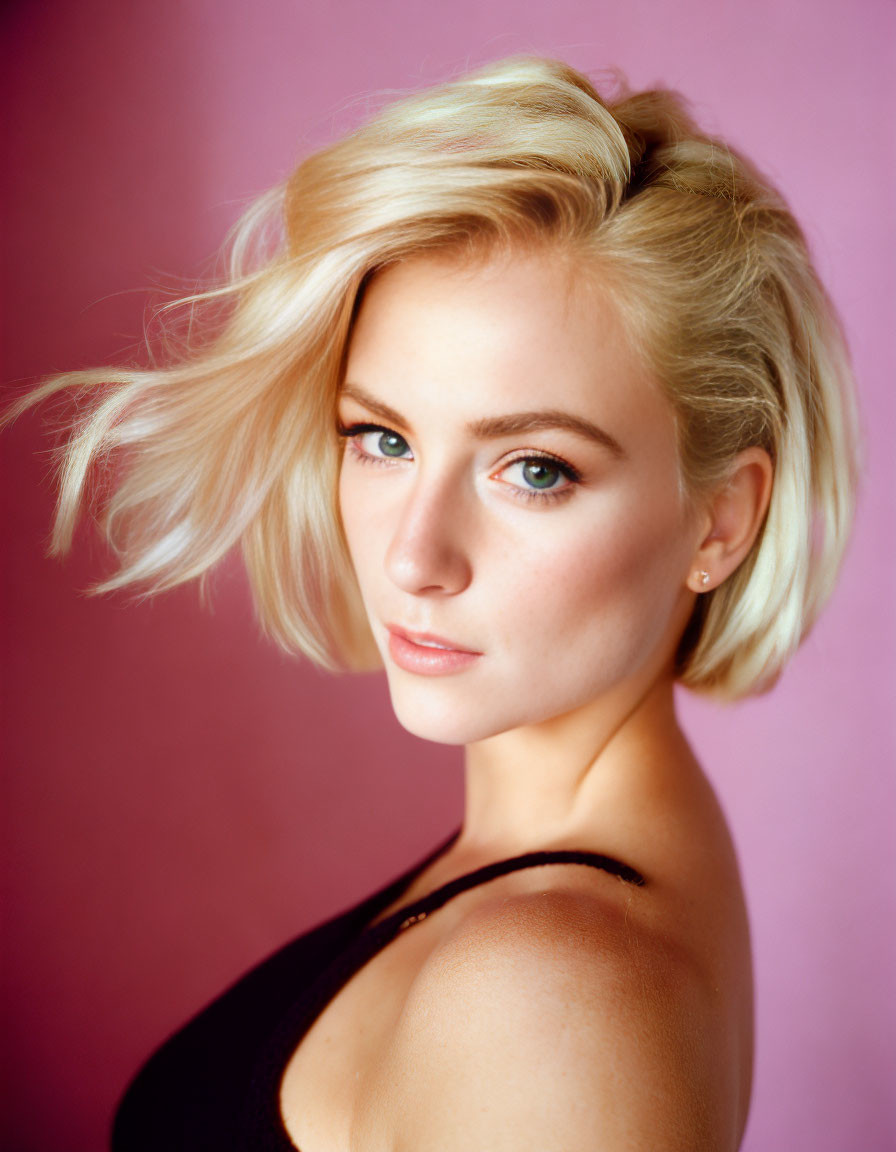 Blonde Woman Portrait with Green Eyes on Pink Background