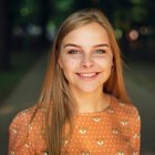 Hyperrealistic Painting: Smiling Girl with Red Hair, Blue Eyes, Orange Coat