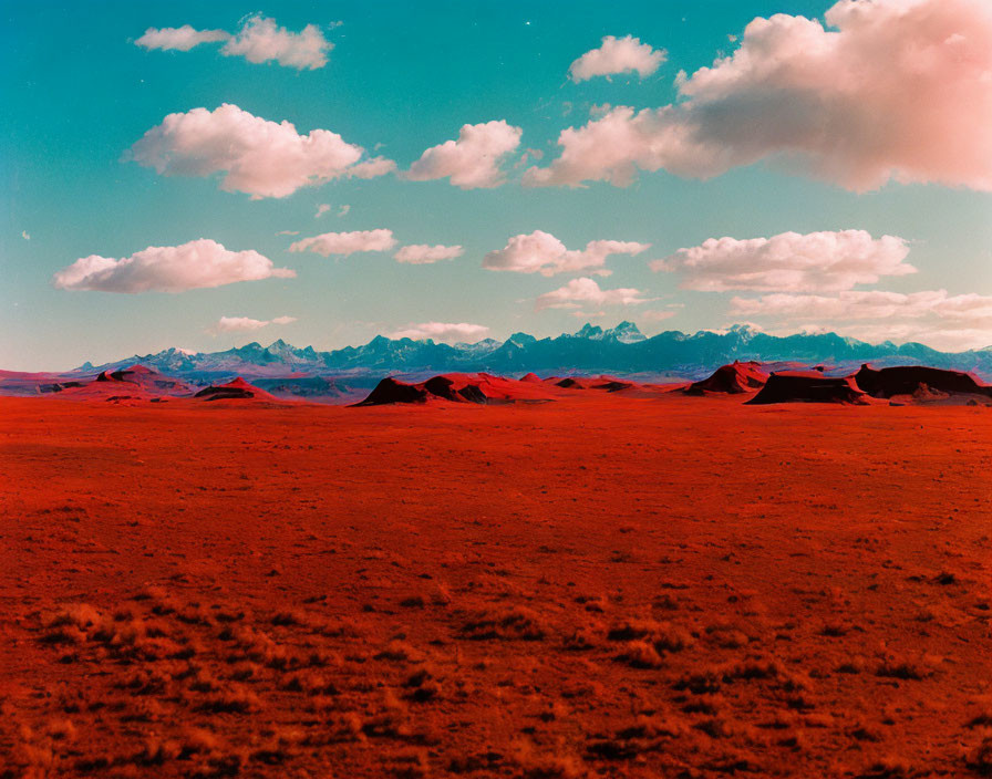 Vivid Red Martian-Like Landscape with Rocky Outcrops