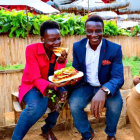 Group of Three People Enjoying Outdoor Meal with Large Sandwiches