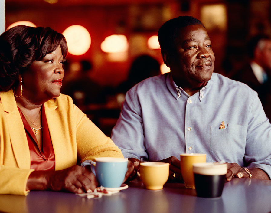 Two people conversing over coffee in a cozy diner setting