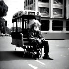 Elderly man with long white hair and beard at urban bus stop