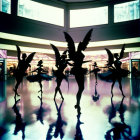 Ballerinas in winged costumes in reflective room