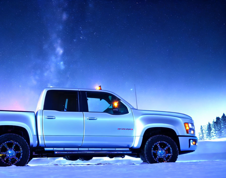 White Pickup Truck Parked on Snow Under Starry Night Sky