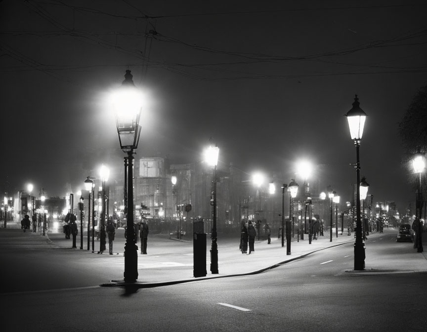 Monochrome urban night scene with row of glowing street lamps