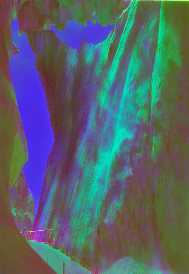 Thermographic image of rugged mountain terrain with cave and vibrant heat signatures