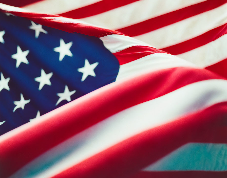 Detailed view of rippled American flag with stars and stripes in shallow focus