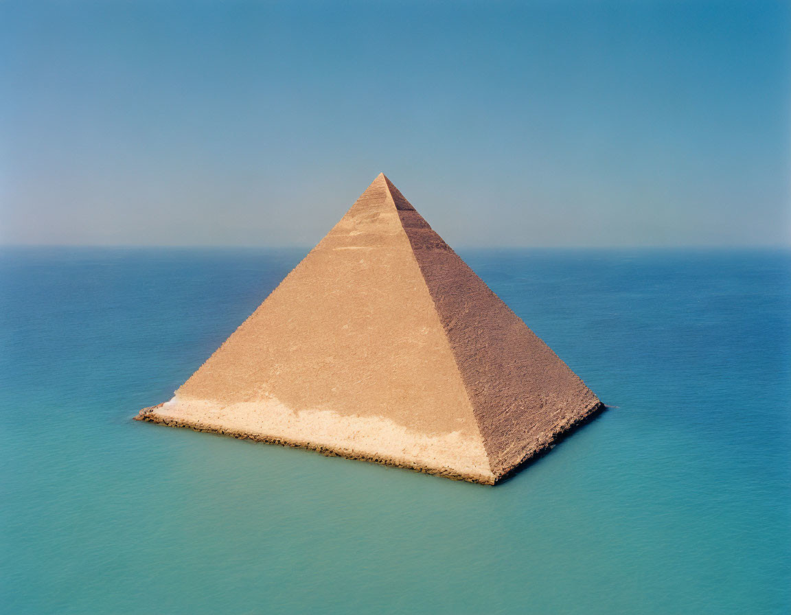 Surreal image of floating pyramid on calm ocean