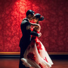 Couple in formal attire dancing against red backdrop