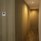 Abstract architectural interior with staggered doorways and warm lighting creating Escher-like illusion