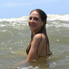 Blonde girl in white dress against blue sky