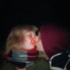 Intimate kiss between two people in warm clothing