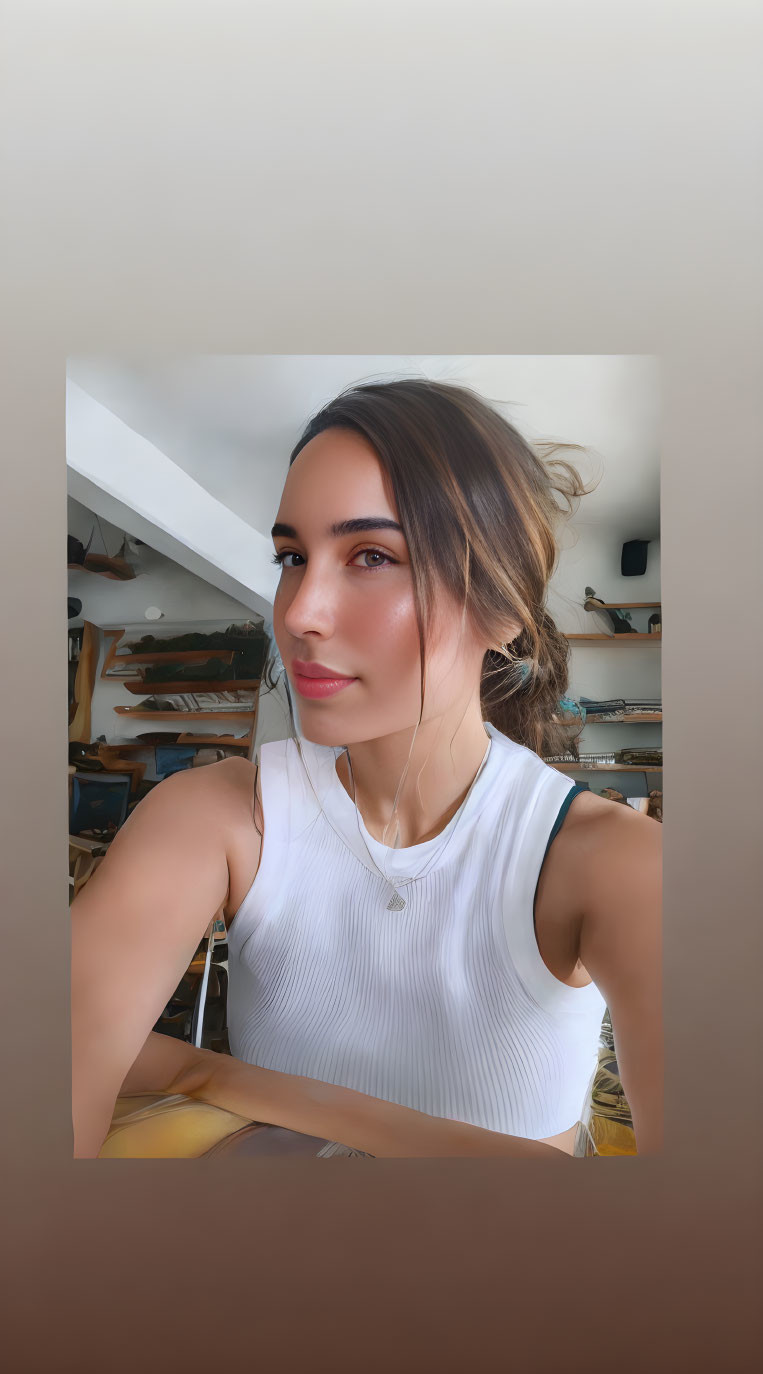 Woman in white top takes selfie with surfboards in background