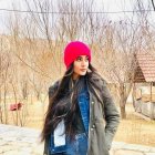 Woman in Pink Beanie and Fur-Trimmed Coat Among Autumn Trees