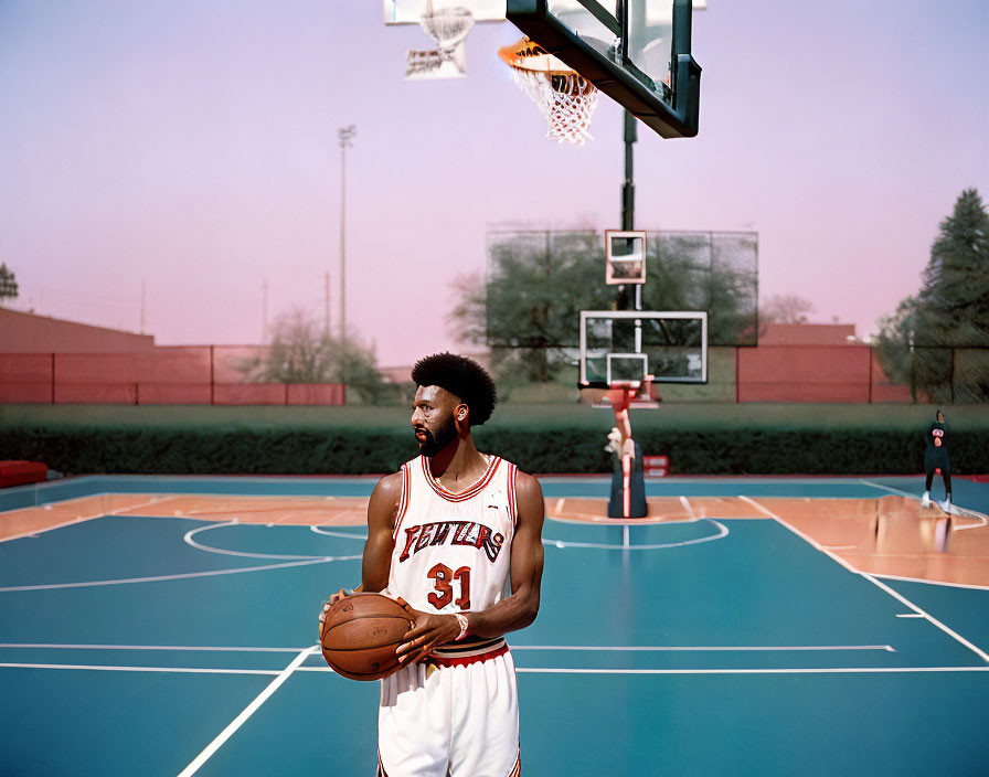 Basketball player in red and white jersey on outdoor court