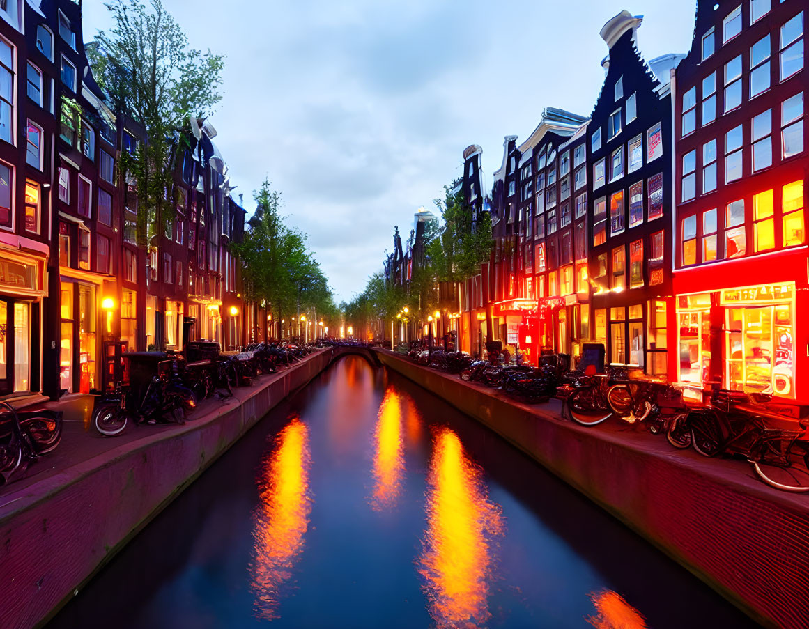 Amsterdam canal at twilight with bicycles and traditional Dutch buildings