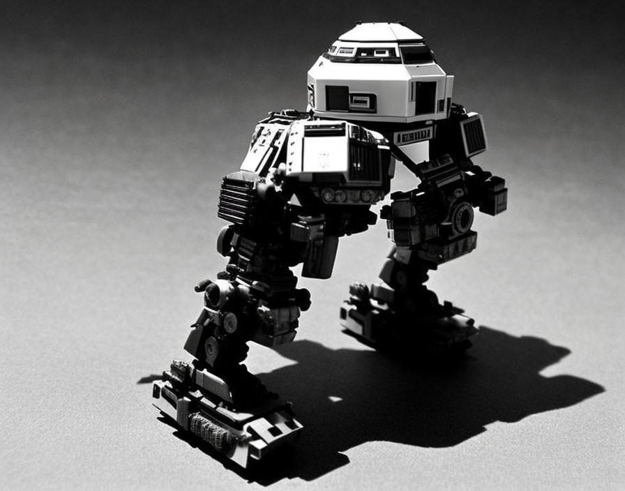 Toy robot with articulated joints on textured surface - Monochrome photo