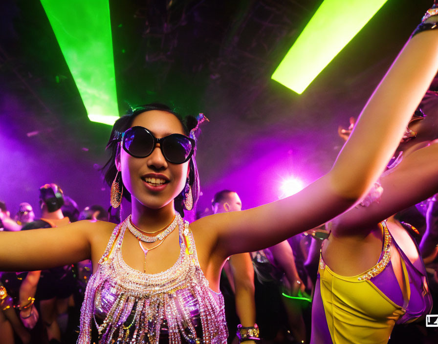 Neon-lit club scene with dancing crowd and woman in glittery attire