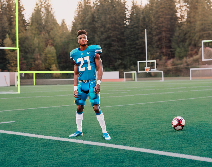 Soccer player in jersey number 27 on field with ball and goalposts