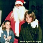 Two children with classic Santa Claus in festive setting