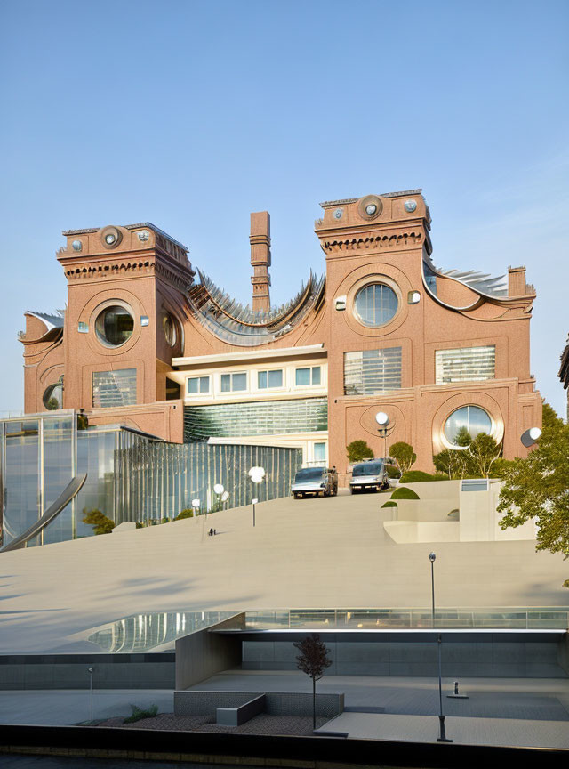 Modern and classical architectural fusion with wavy glass facade and red brick sections