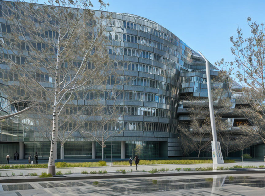 Contemporary glass building with external staircases, trees, and pedestrians on sunny day