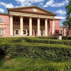 Neoclassical building with columns and pediment in nature scene