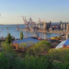 Panoramic cityscape with skyscrapers and waterfront view under clear blue sky