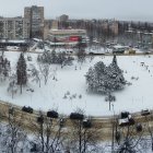 Modern campus with rounded buildings and snow-covered trees in panoramic view