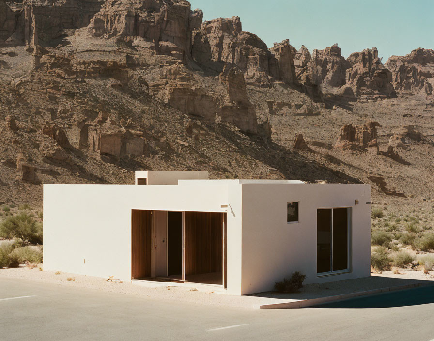 Modern White Building in Desert Landscape with Mountains