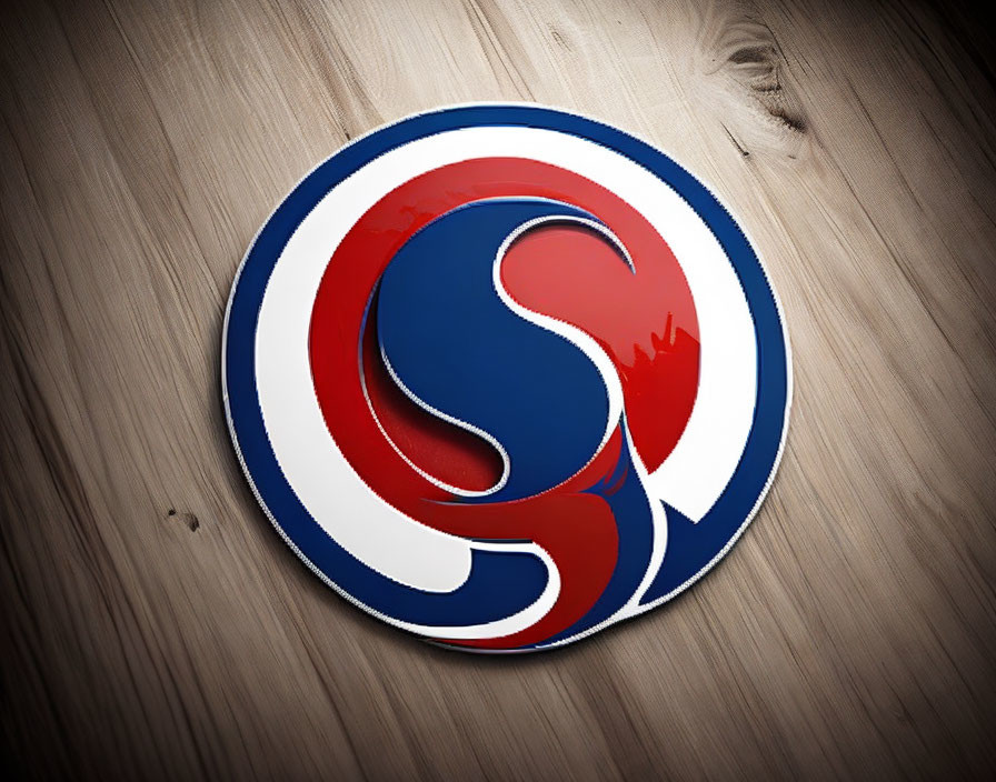 Circular red and blue swirled logo on wooden background