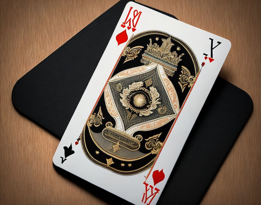 Black and Gold King of Spades Playing Card on Wooden Surface