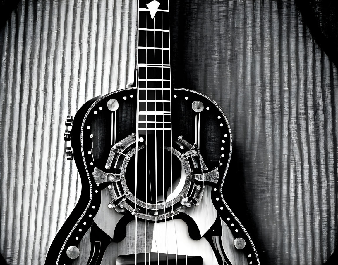 Monochrome resonator guitar with metal decorations on striped backdrop