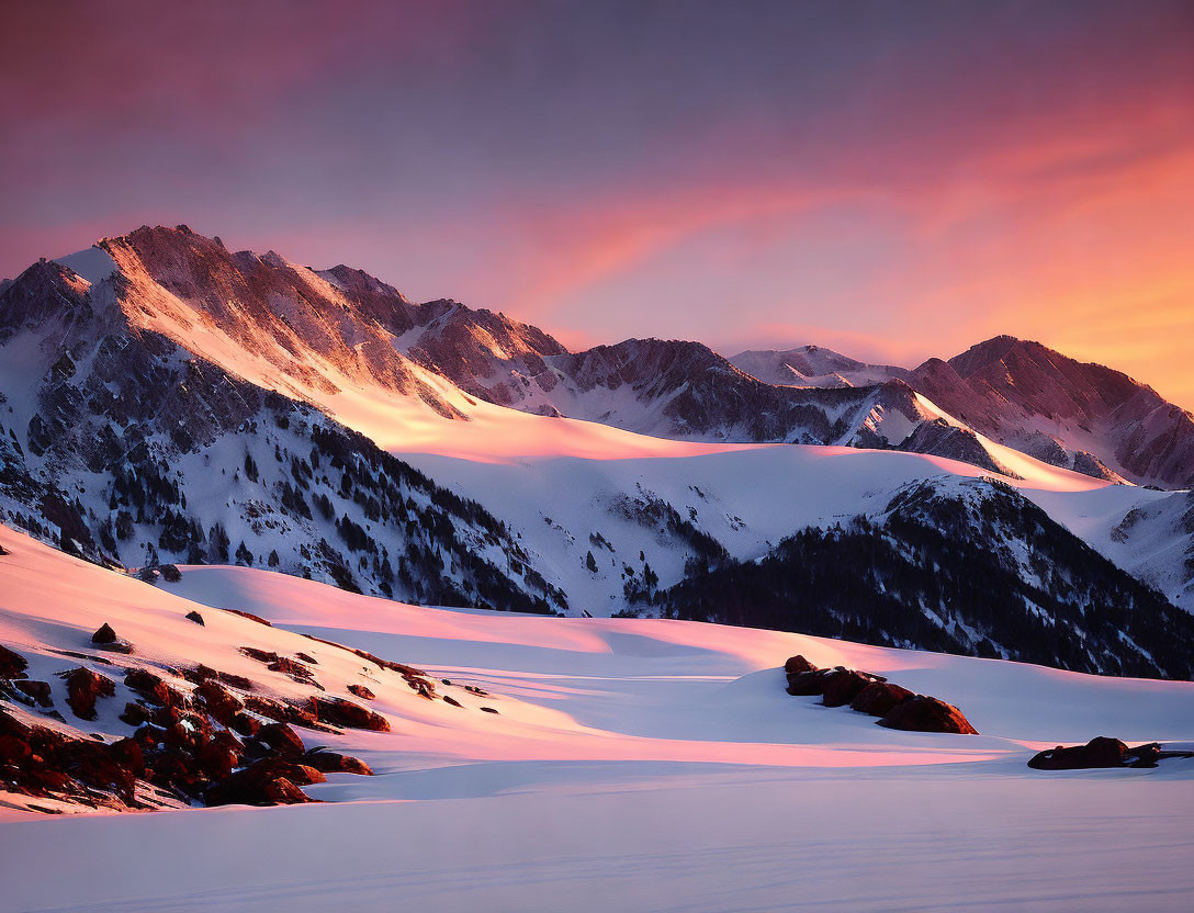 Snow-capped mountain peaks in vibrant sunrise scene