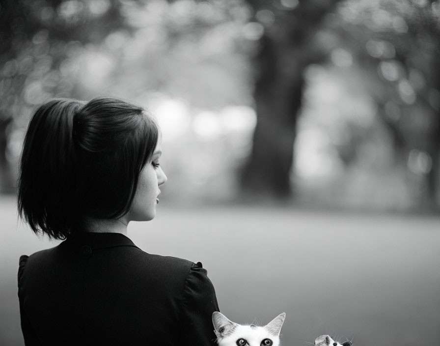 Woman with Cat in Profile Against Natural Background