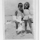 Young girls in iridescent dresses and hats with seashells and bubbles by the seaside